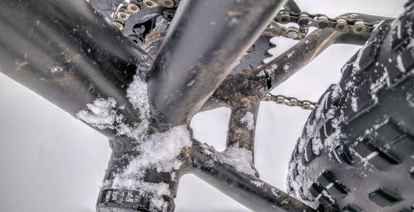 Close-up of cracked bicycle chainstay showing metal fatigue failure