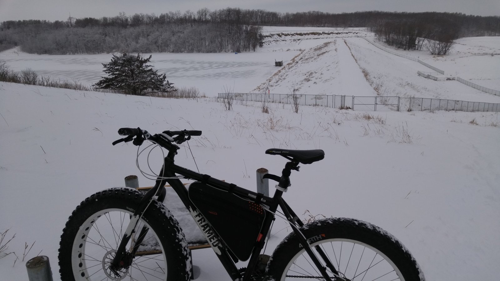 Steel fat bike with oversized tires in snowy winter landscape